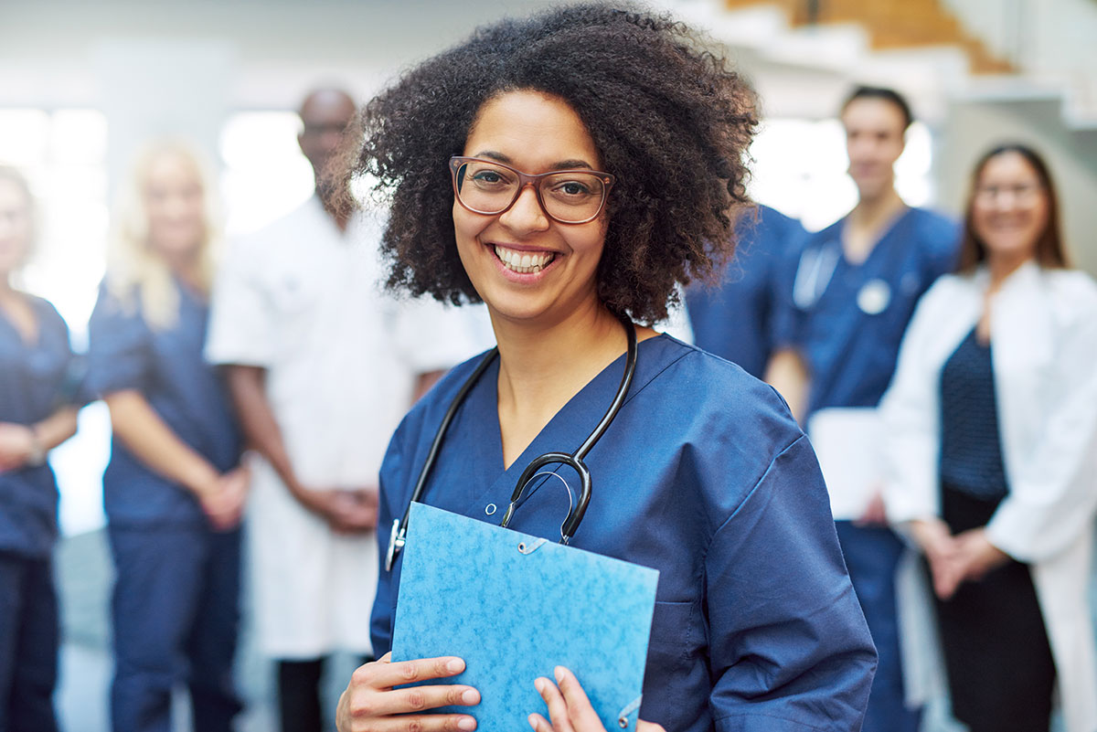 A smiling medical student holding a folder