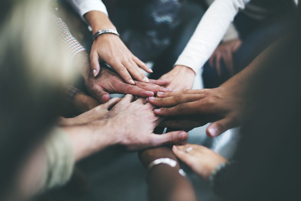 Hands coming together in a circle