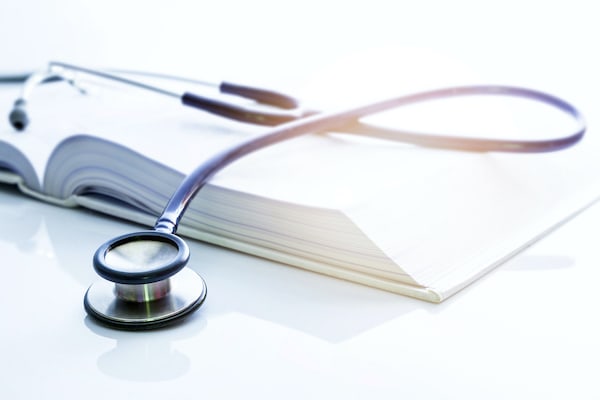 journal-with-stethoscope-S A stethoscope laying on top of a medical journal.